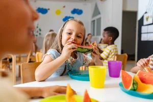 nursery girl eating a watermelon