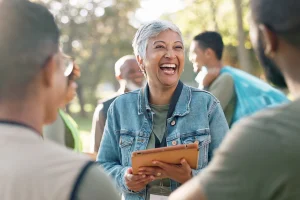 support worker laughing with a clipboard